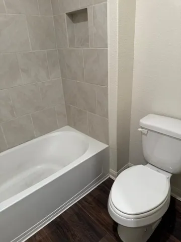 a bathroom with a toilet a sink and bathtub