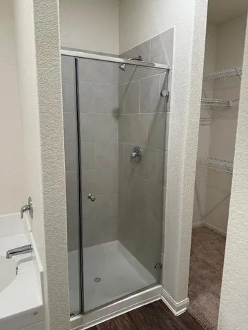 a bathroom with a granite countertop sink toilet and shower