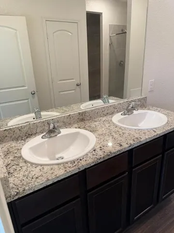 a white toilet sitting next to a bathroom sink