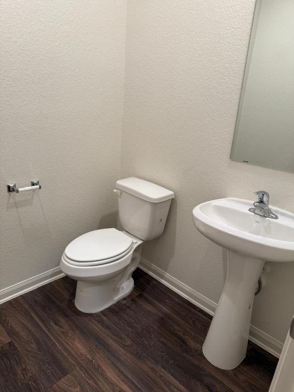 14325 Boomtown Way Elgin, TX 78621 - Photo 27 of 29 a white toilet sitting next to a bathroom sink