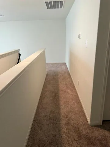 a view of a hallway with stairs