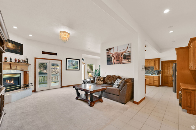 1085 Windsor Drive Provo, UT 84604 - Photo 12 of 83 Living area with recessed lighting, light tile patterned floors, light carpet, a fireplace, and a chandelier