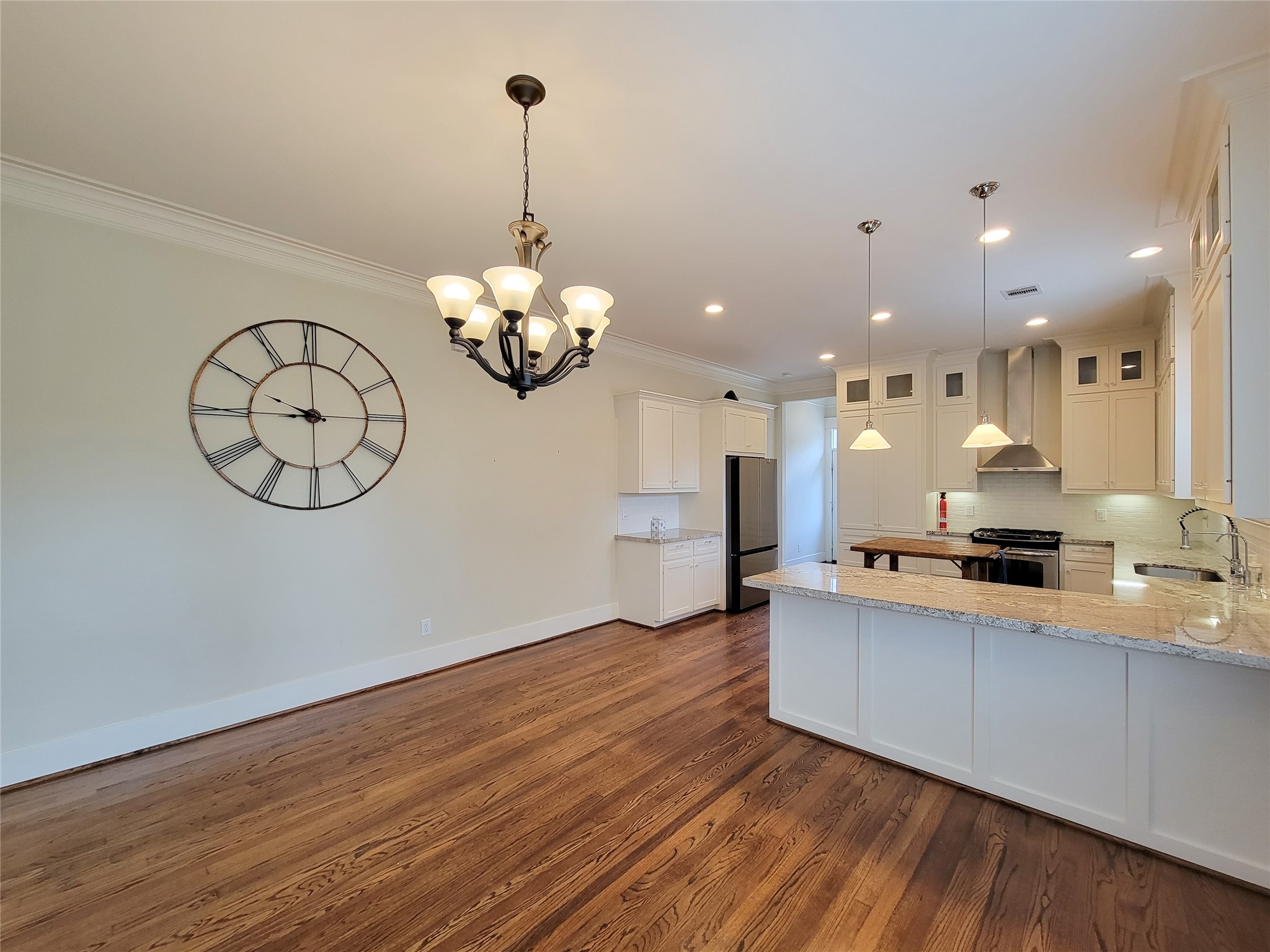1140 West Cottage Street Houston, TX 77009 - Photo 12 of 37 a large kitchen with stainless steel appliances a large stove a sink dishwasher and a fireplace with wooden floor