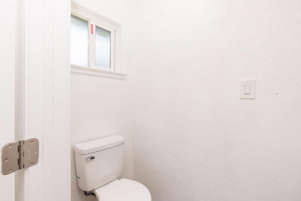 28369 Road 400 Madera, CA 93636 - Photo 12 of 33 a white toilet sitting next to a white wall