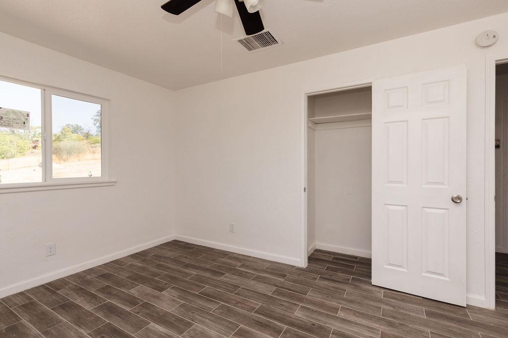 28369 Road 400 Madera, CA 93636 - Photo 14 of 33 a view of an empty room with wooden floor and a window
