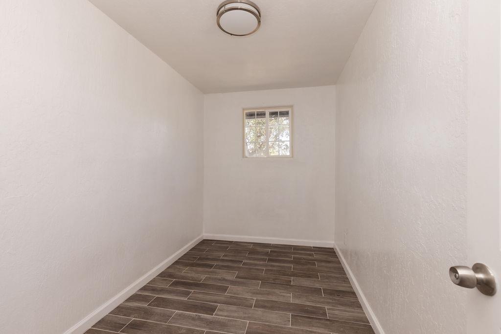 28369 Road 400 Madera, CA 93636 - Photo 16 of 33 a view of a room with wooden floor and window