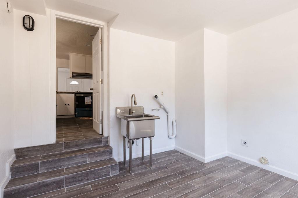 28369 Road 400 Madera, CA 93636 - Photo 17 of 33 a view of a hallway with wooden floor and furniture
