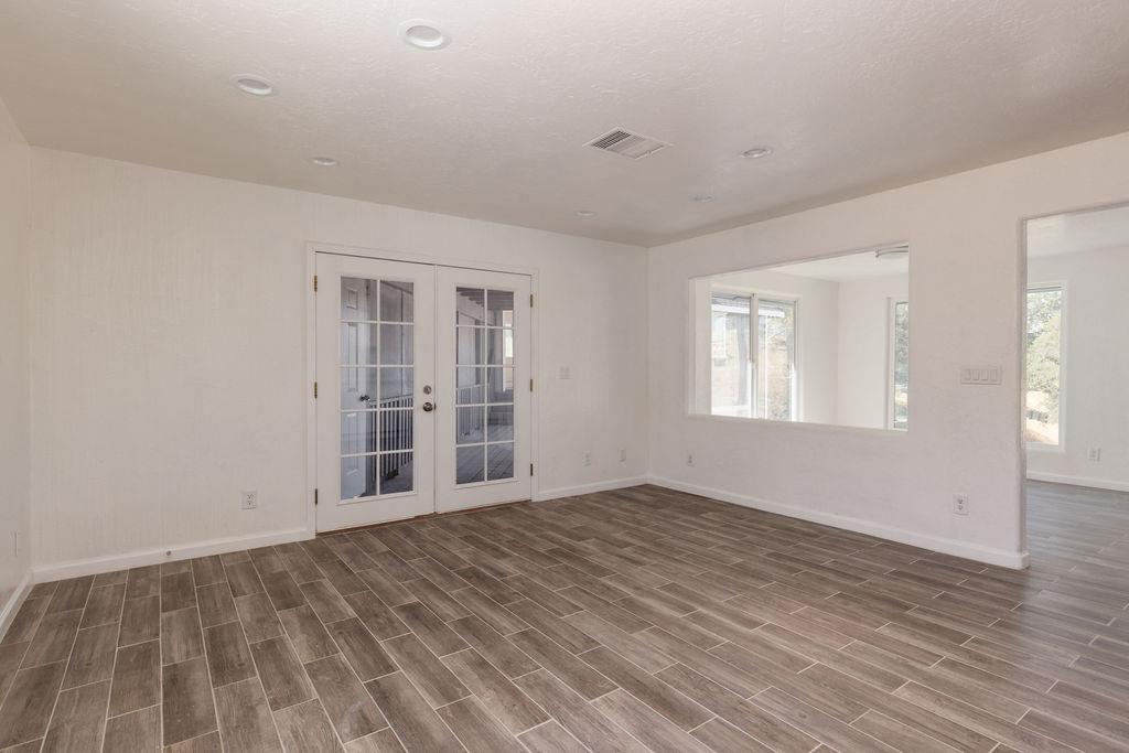 28369 Road 400 Madera, CA 93636 - Photo 2 of 33 a view of an empty room with wooden floor and windows