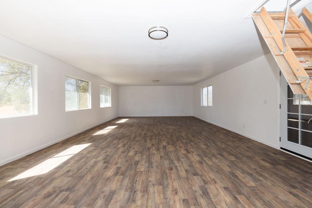 28369 Road 400 Madera, CA 93636 - Photo 21 of 33 a view of empty room with wooden floor and fan