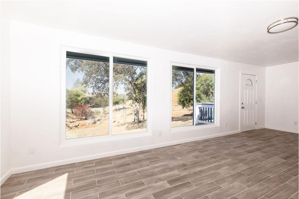 28369 Road 400 Madera, CA 93636 - Photo 4 of 33 a view of an empty room with wooden floor and a window