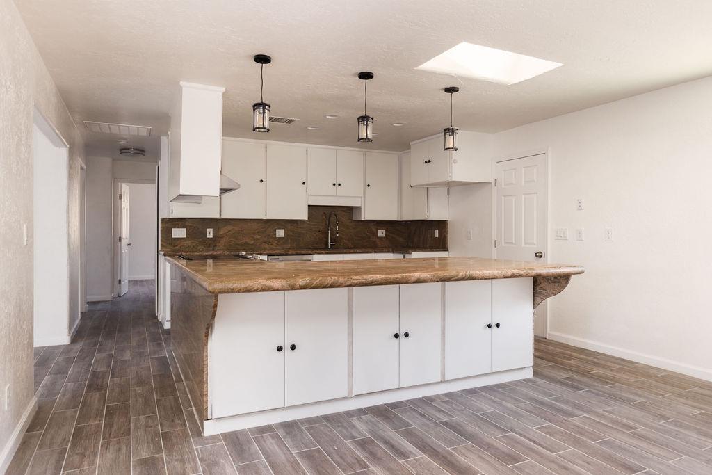 28369 Road 400 Madera, CA 93636 - Photo 5 of 33 a kitchen with stainless steel appliances granite countertop a sink a stove and a refrigerator