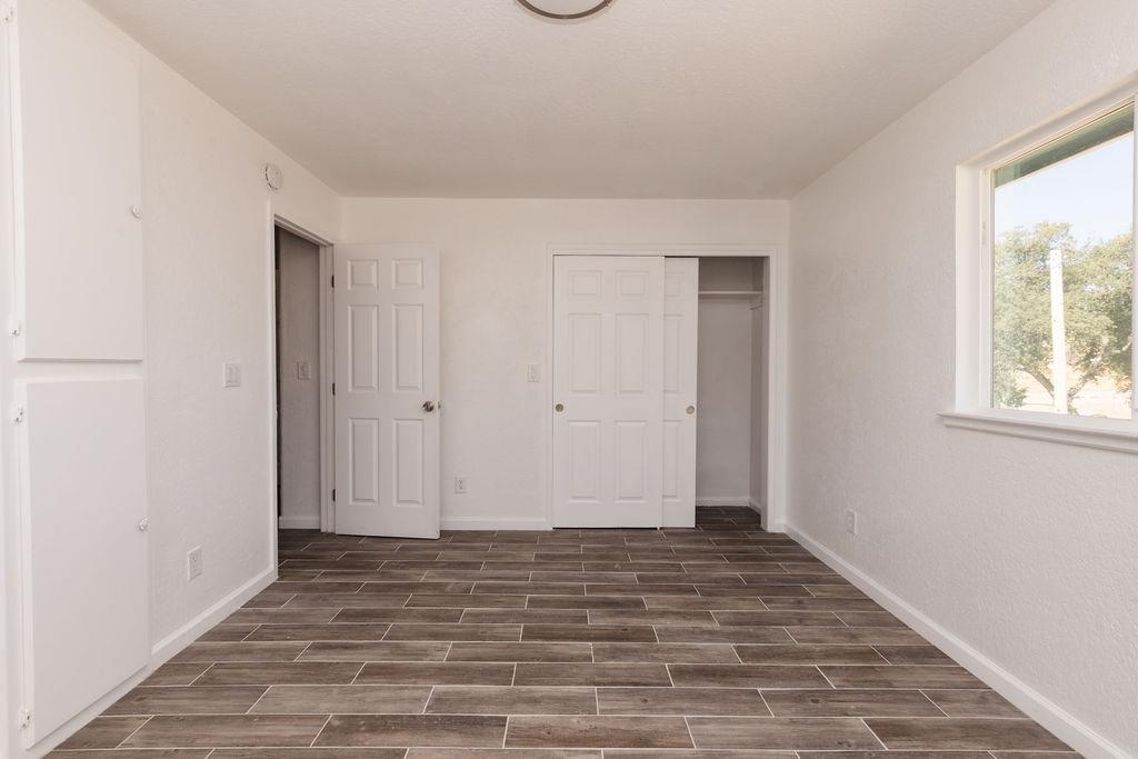 28369 Road 400 Madera, CA 93636 - Photo 10 of 33 a view of an empty room with window and wooden floor
