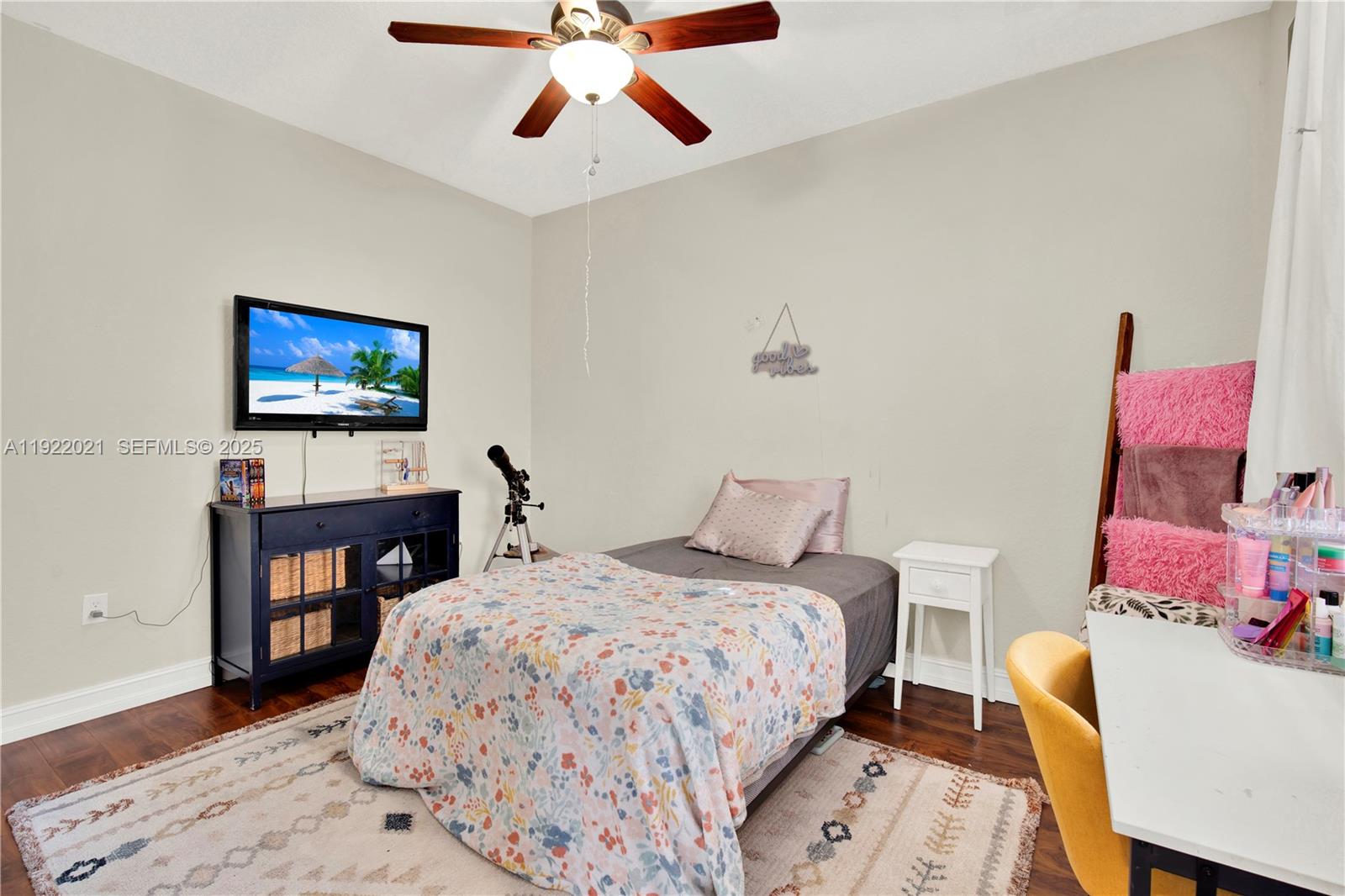 1121 Southwest 147th Terrace Pembroke Pines, FL 33027 - Photo 16 of 32 a bedroom with a bed and a flat screen tv