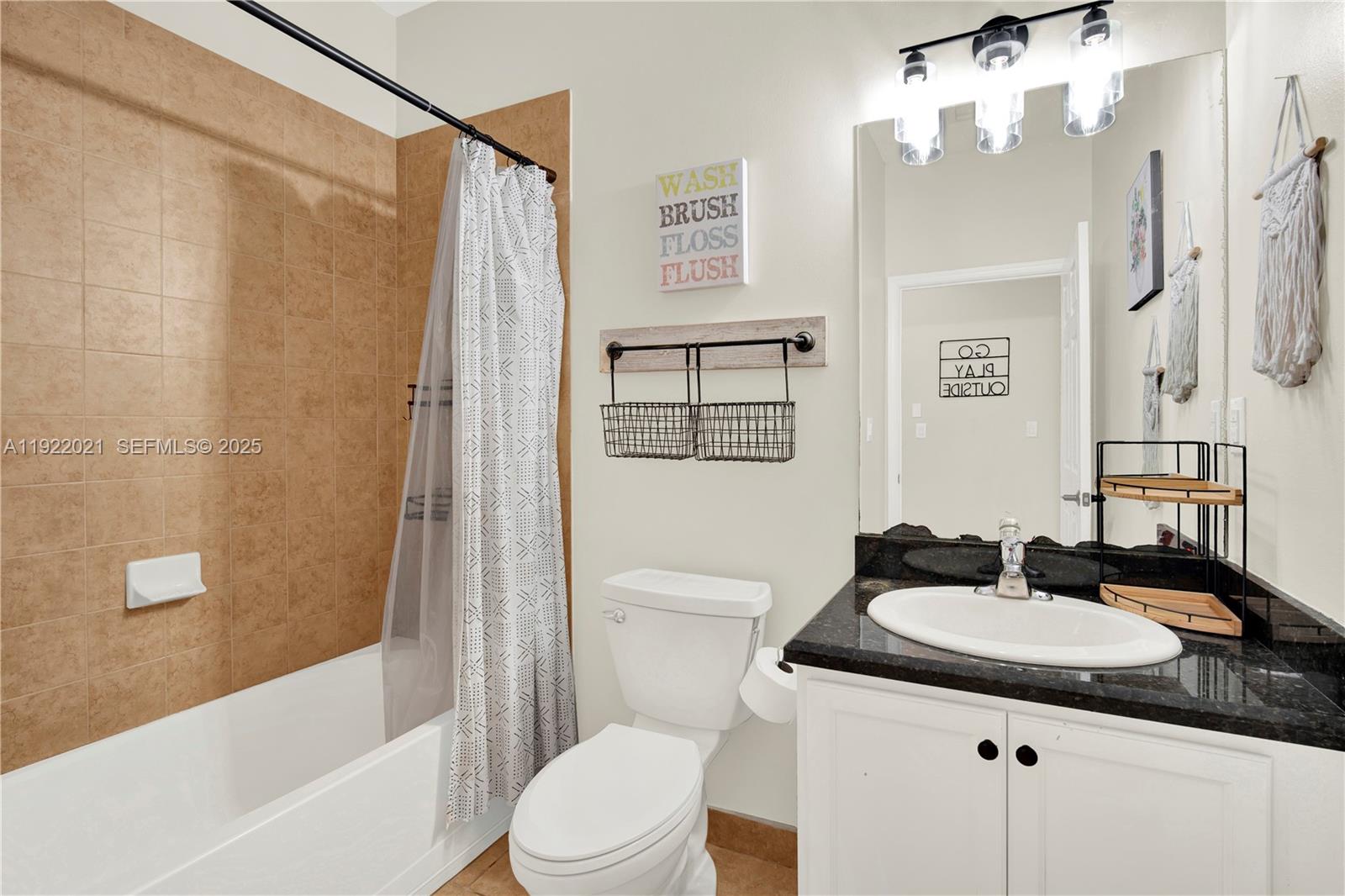 1121 Southwest 147th Terrace Pembroke Pines, FL 33027 - Photo 17 of 32 a bathroom with a sink a toilet a mirror a vanity and shower