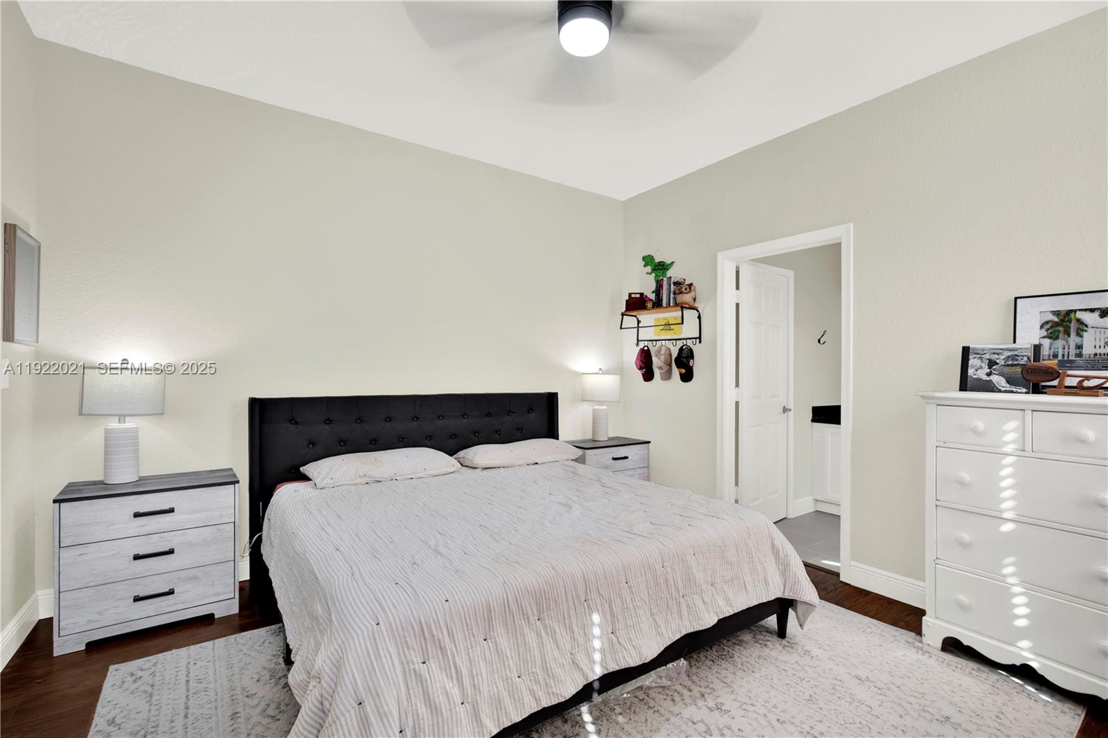 1121 Southwest 147th Terrace Pembroke Pines, FL 33027 - Photo 20 of 32 a bedroom with a bed and a cabinets