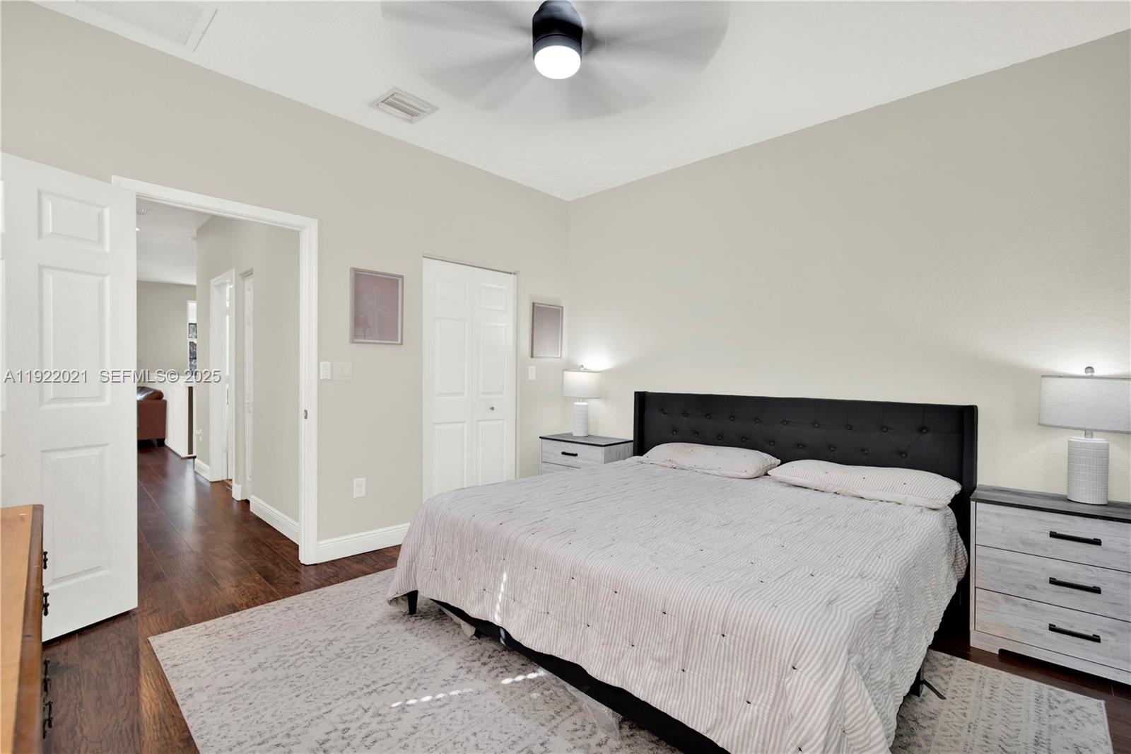 1121 Southwest 147th Terrace Pembroke Pines, FL 33027 - Photo 21 of 32 a bedroom with a bed and wooden floor