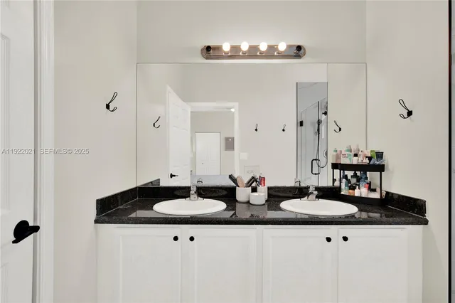 a sink with a mirror and vanity