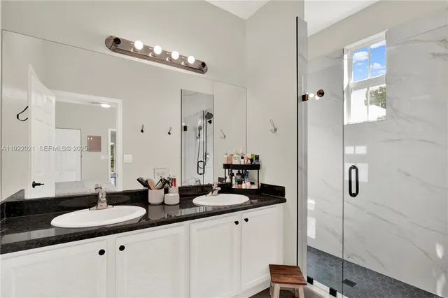 a bathroom with a double vanity sink and mirror