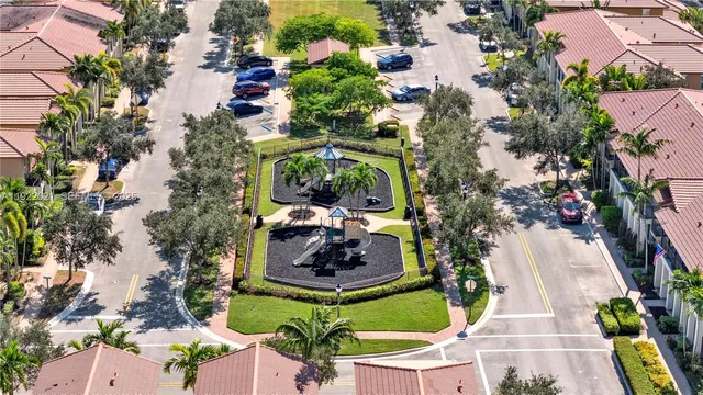 an aerial view of a house with a yard and large trees