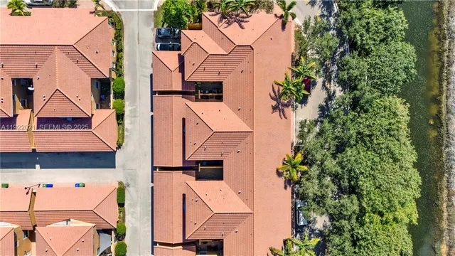 an aerial view of residential houses with outdoor space