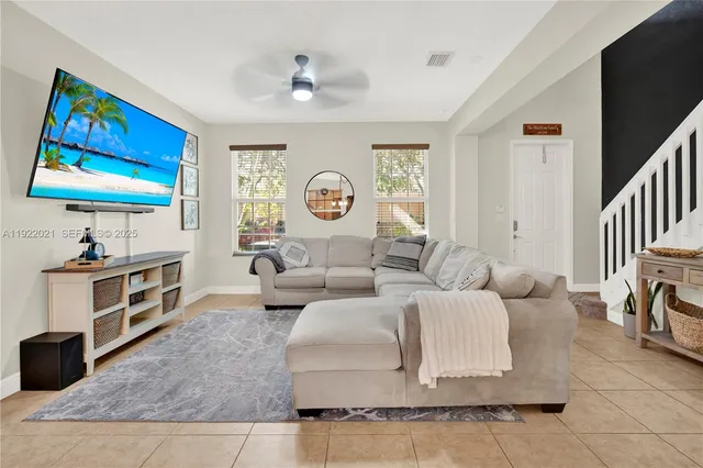 a living room with fireplace furniture and a flat screen tv