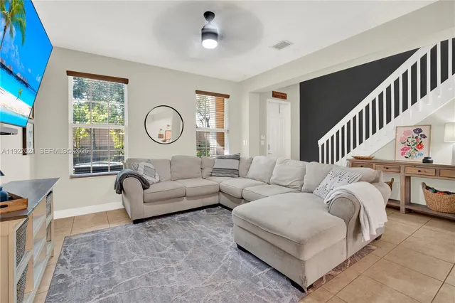 a living room with furniture and a large window