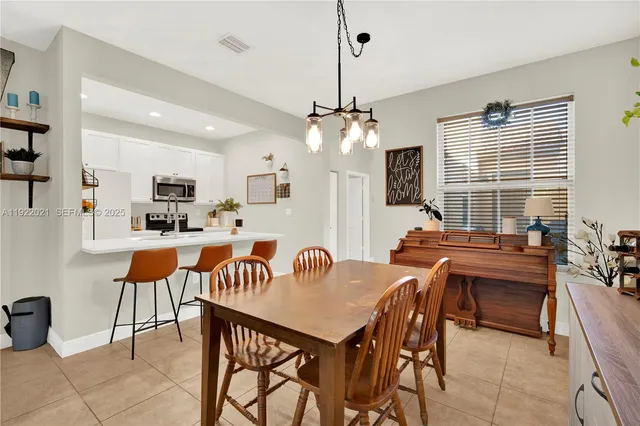 a view of a dining room with furniture and a chandelier
