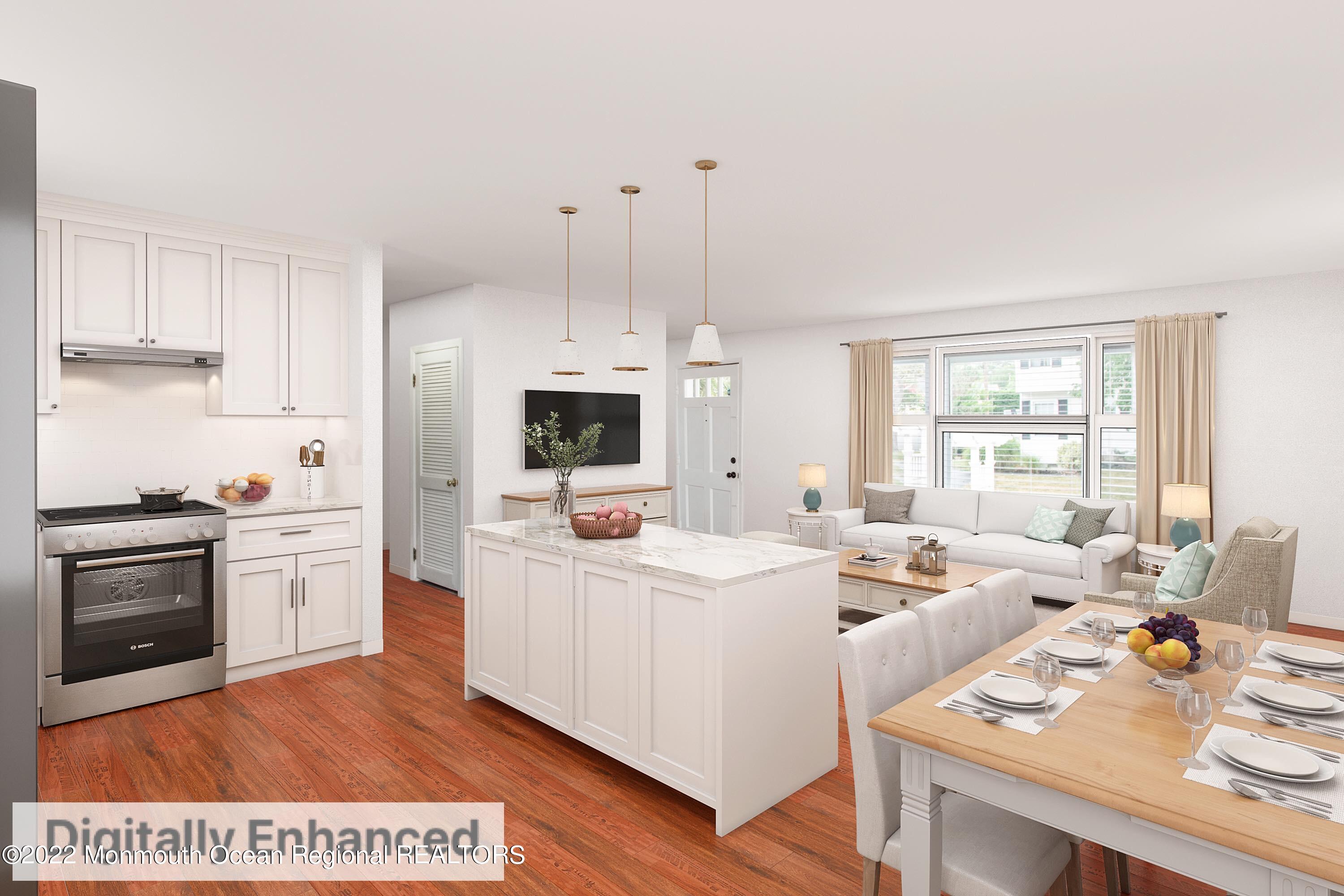 111 Manito Road Manasquan, NJ 08736 - Photo 13 of 37 a open kitchen with stainless steel appliances kitchen island granite countertop a sink dishwasher stove and white cabinets with wooden floor
