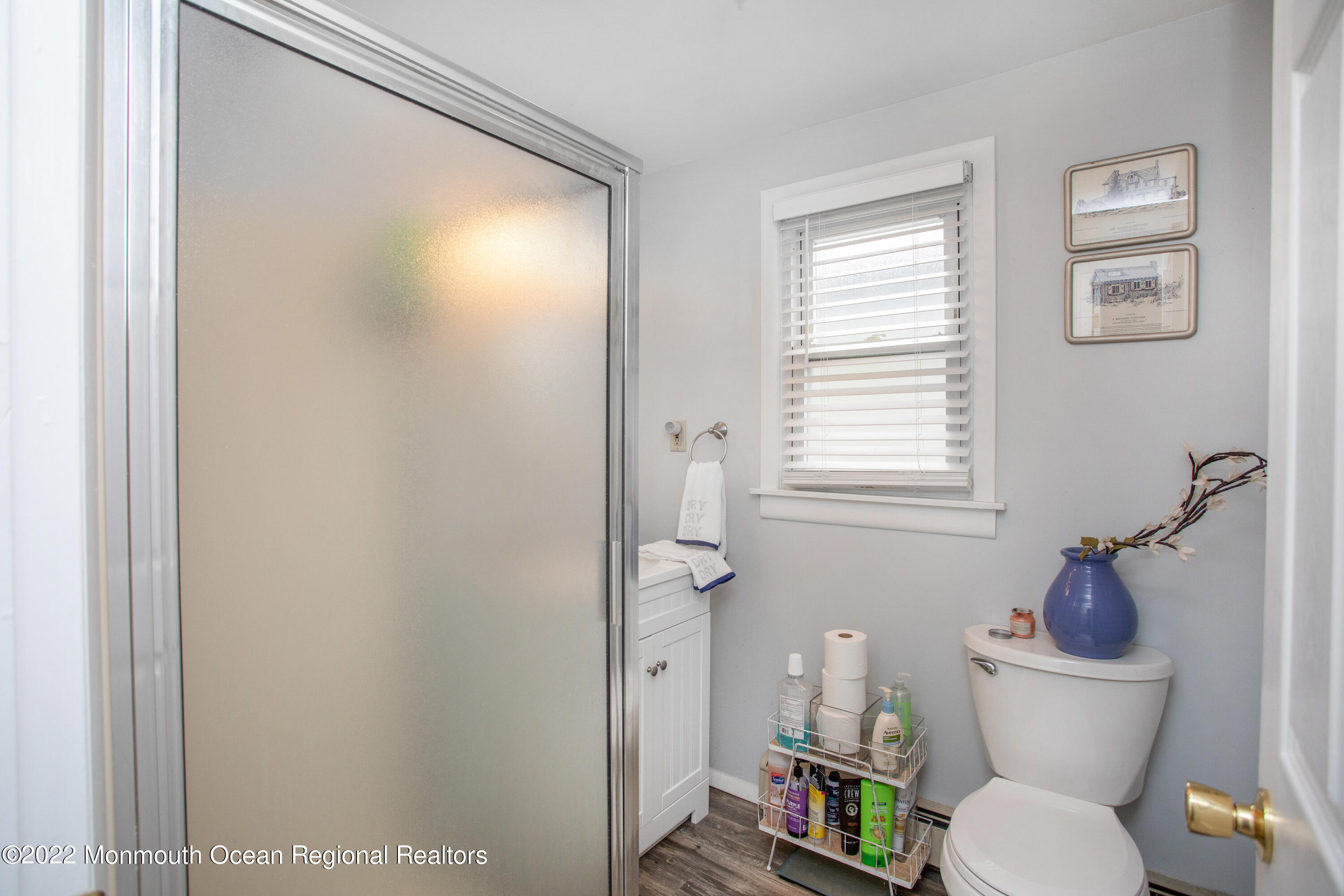 111 Manito Road Manasquan, NJ 08736 - Photo 24 of 37 a white toilet sitting next to a bathroom sink and tub