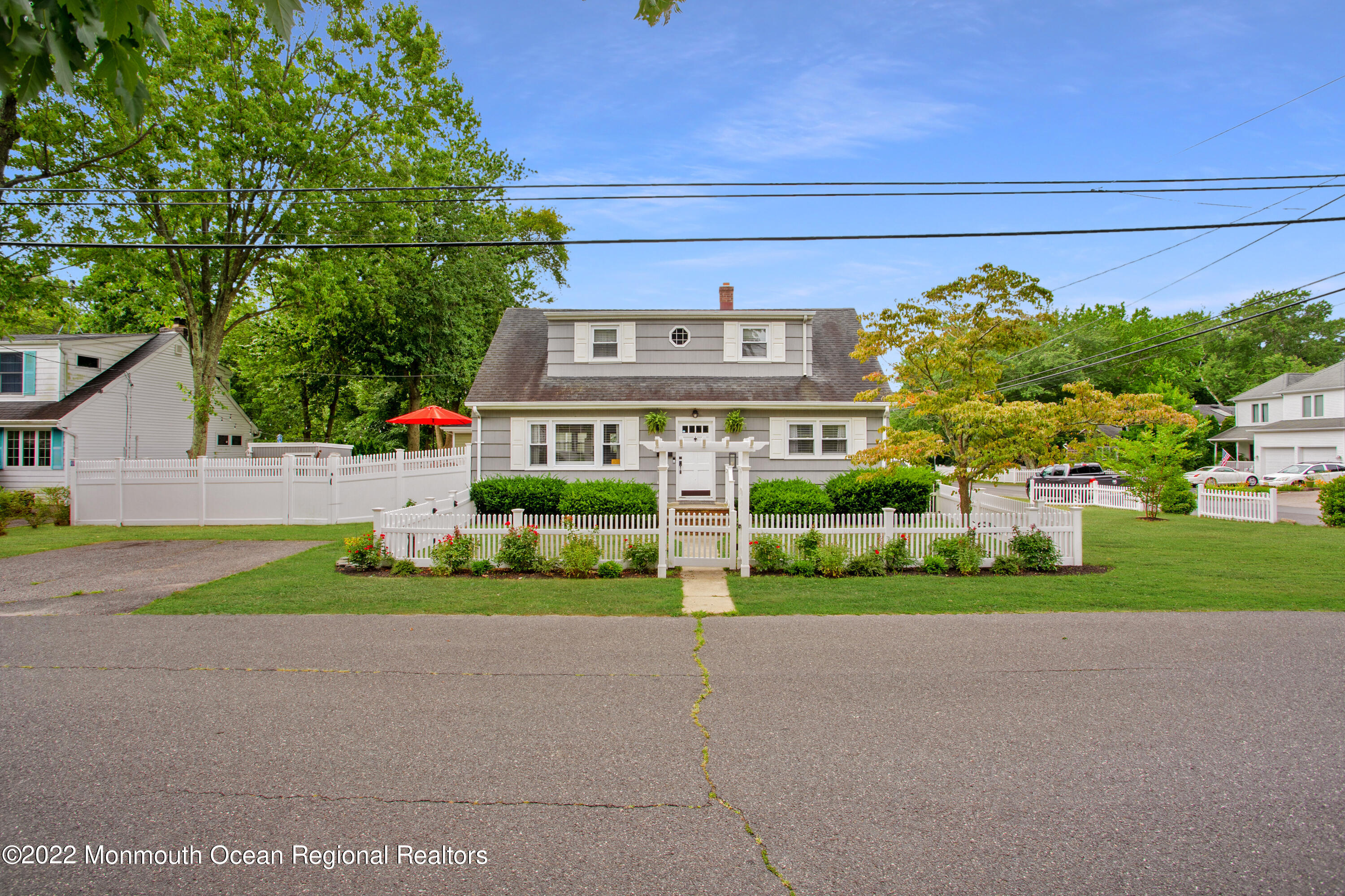 111 Manito Road Manasquan, NJ 08736 - Photo 4 of 37 a front view of a house with a yard and garage