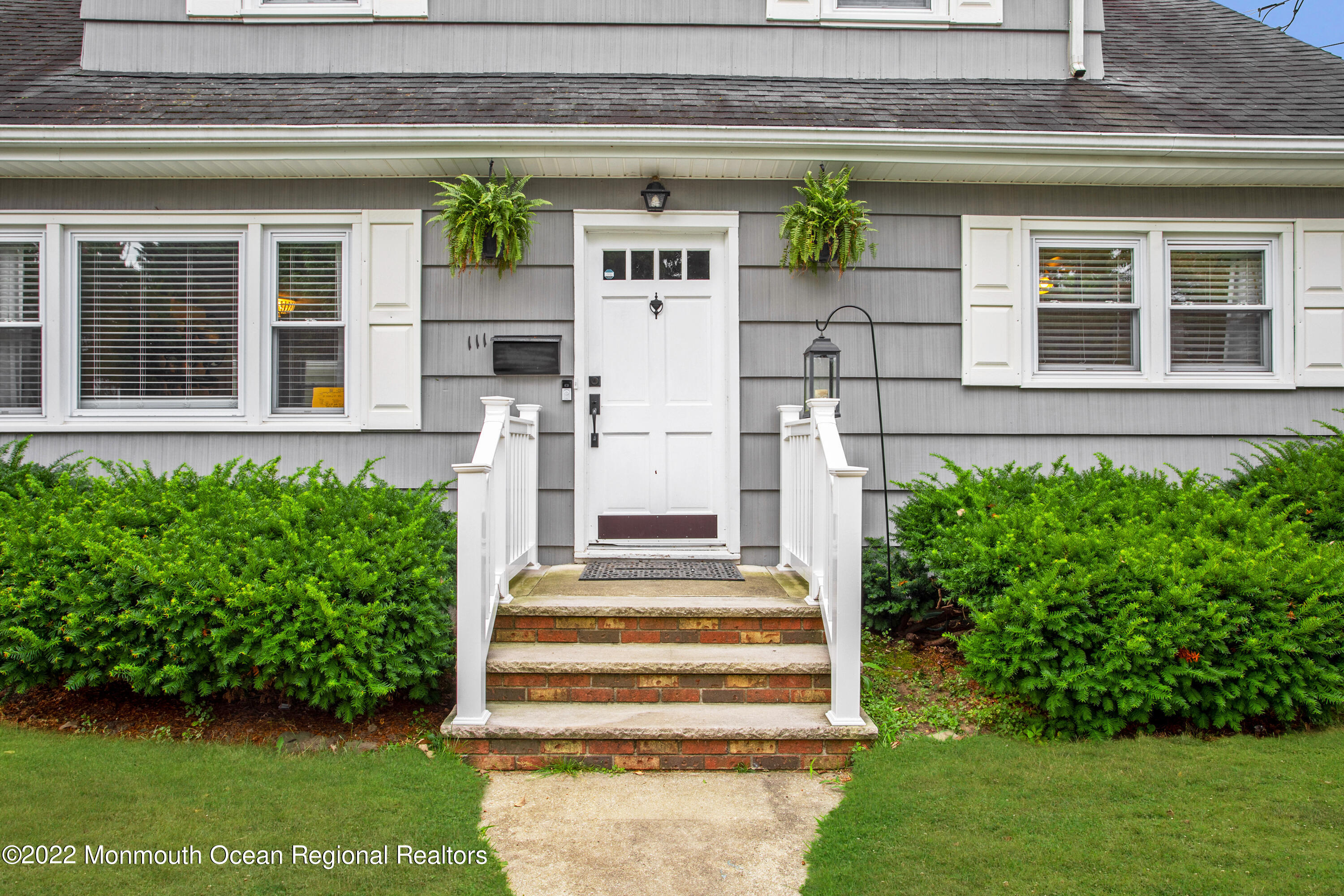 111 Manito Road Manasquan, NJ 08736 - Photo 6 of 37 a front view of a house with a garden
