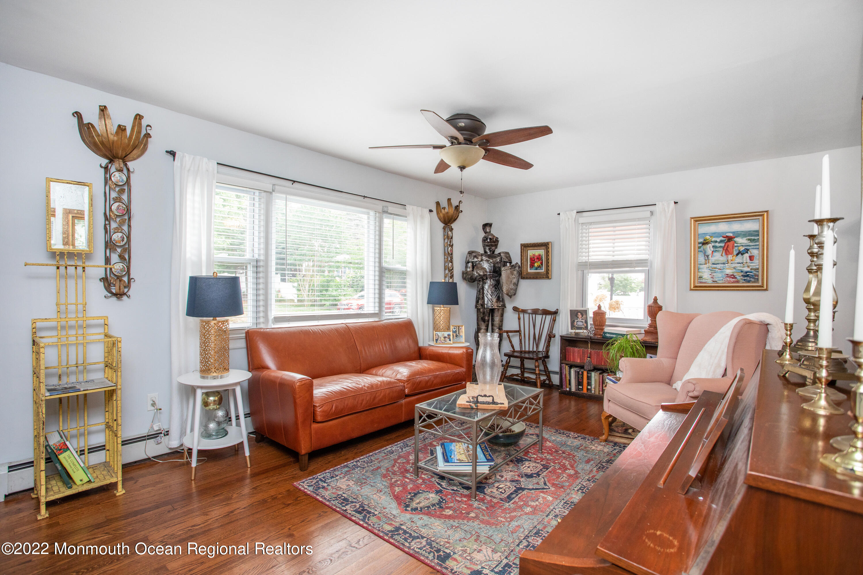 111 Manito Road Manasquan, NJ 08736 - Photo 10 of 37 a living room with furniture a chandelier and a large window