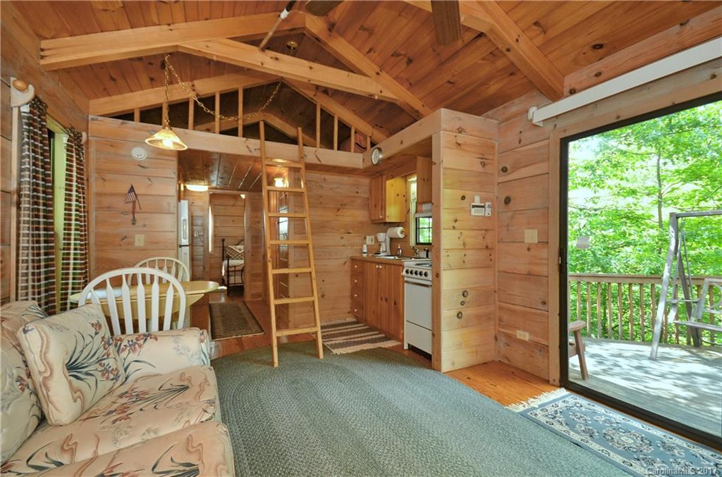 381 Norman Road Clyde, NC 28721 - Photo 18 of 21 a view of a balcony with furniture and floor to ceiling window