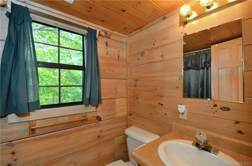 381 Norman Road Clyde, NC 28721 - Photo 21 of 21 a bathroom with a sink and a bathtub