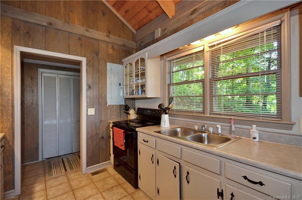 381 Norman Road Clyde, NC 28721 - Photo 5 of 21 a kitchen with a sink and large window
