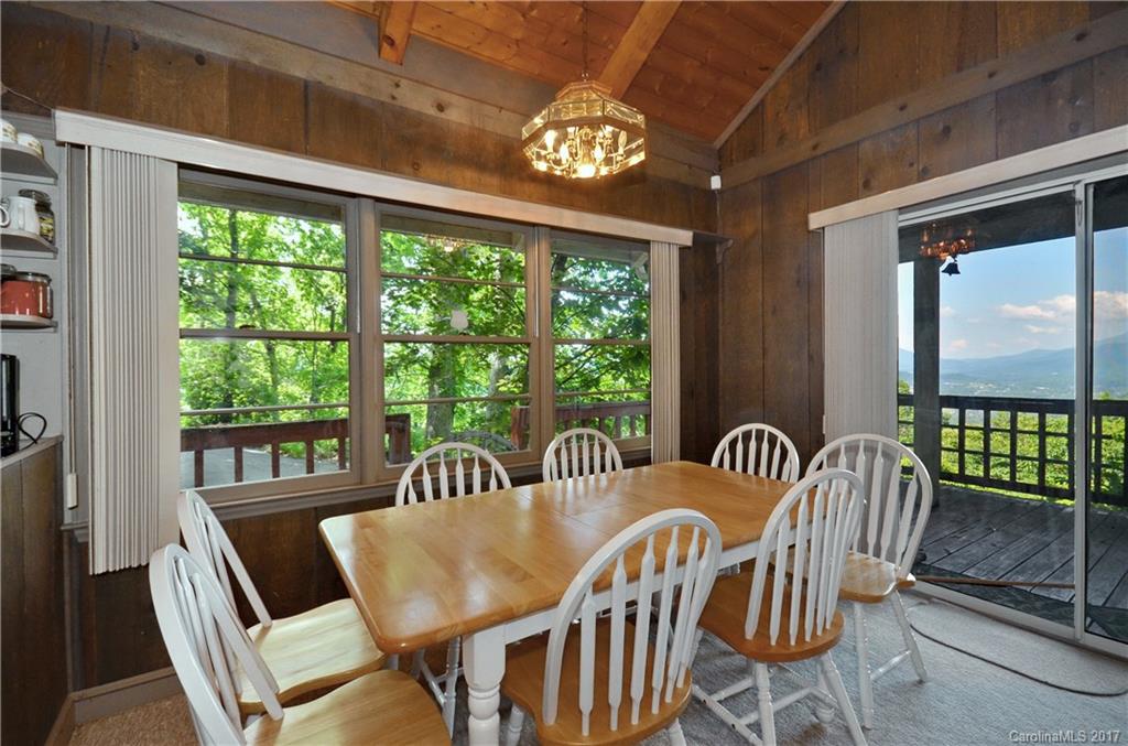 381 Norman Road Clyde, NC 28721 - Photo 6 of 21 a view of a dining room with furniture a chandelier and a large window