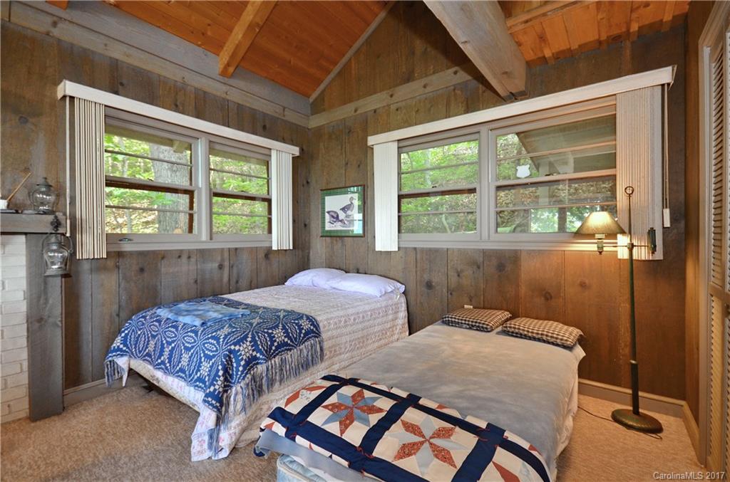 381 Norman Road Clyde, NC 28721 - Photo 7 of 21 a bedroom with two beds and a window