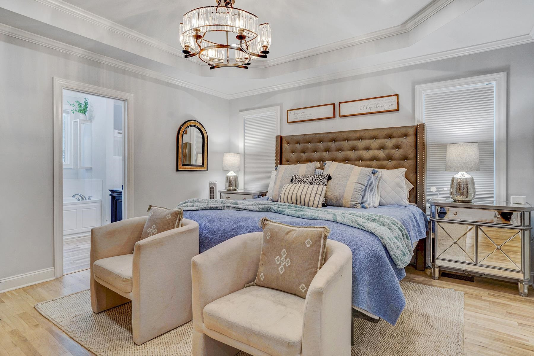 163 Winfred Drive Raleigh, NC 27603 - Photo 27 of 39 a bedroom with a bed and a chandelier