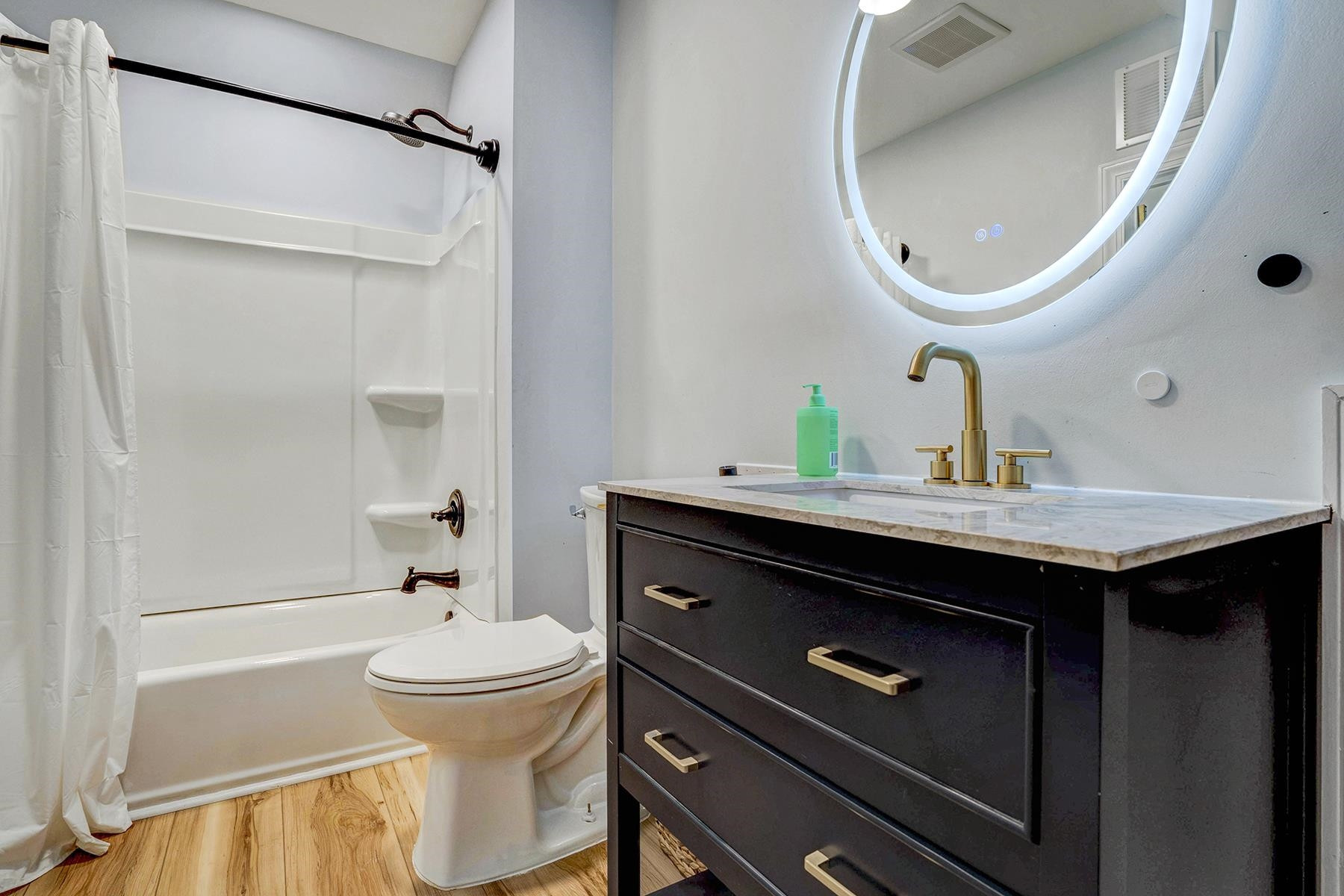 163 Winfred Drive Raleigh, NC 27603 - Photo 34 of 39 a bathroom with a sink a toilet and a mirror