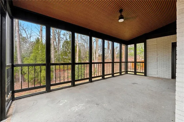 a backyard of a house with barbeque oven table and chairs