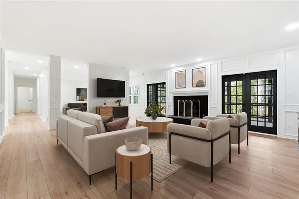 a view of a livingroom with wooden floor and a fireplace
