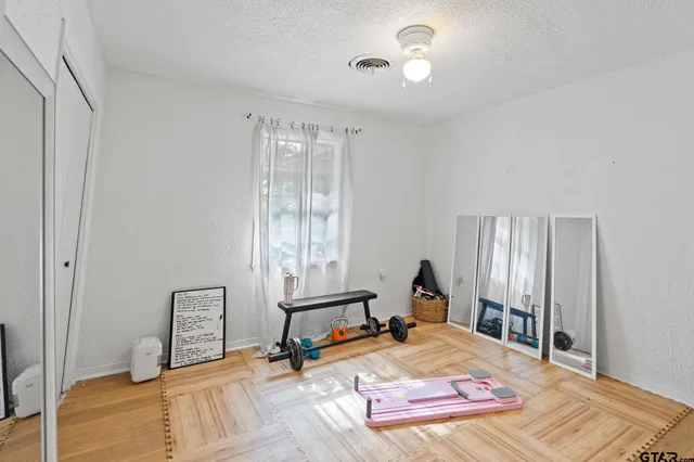 a room with a bed and wooden floor