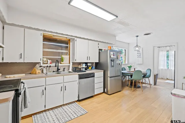 a kitchen with a sink stove and cabinets