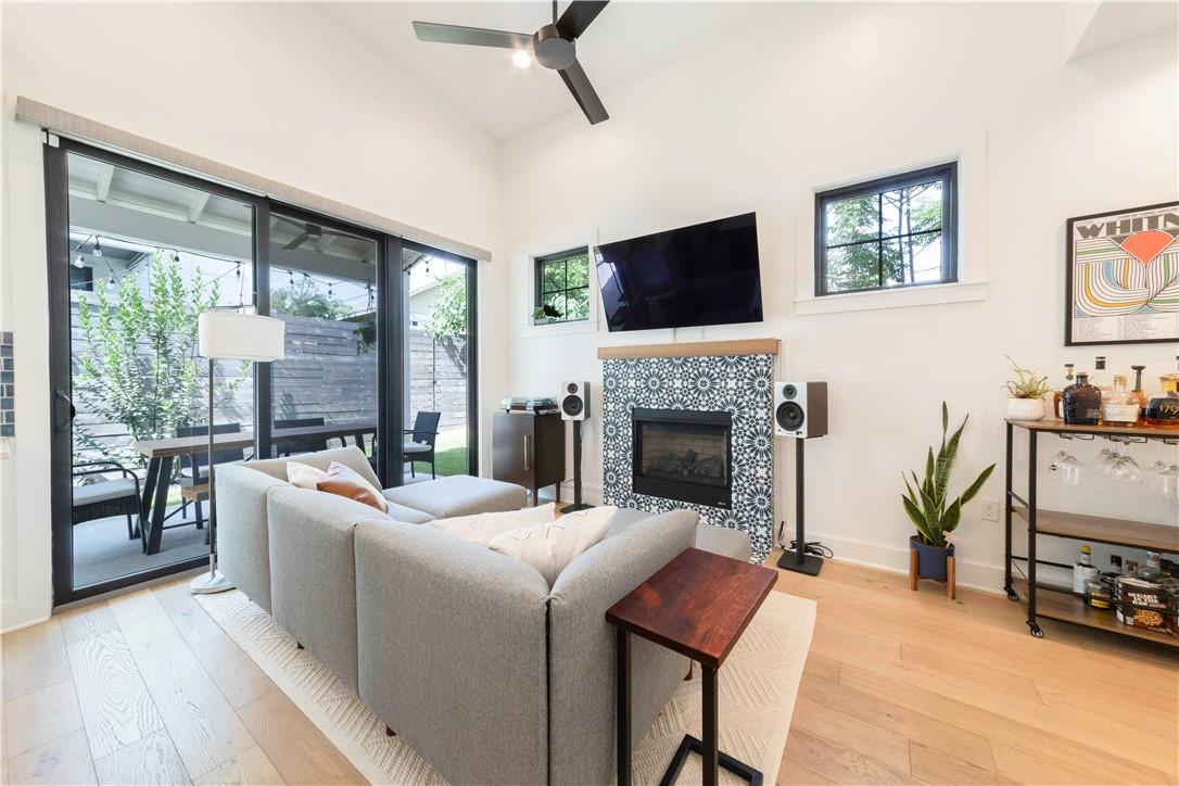 2002 East 9th Street, Unit 2 Austin, TX 78702 - Photo 3 of 32 Natural light floods this inviting living space, connecting seamlessly with the private outdoor patio.