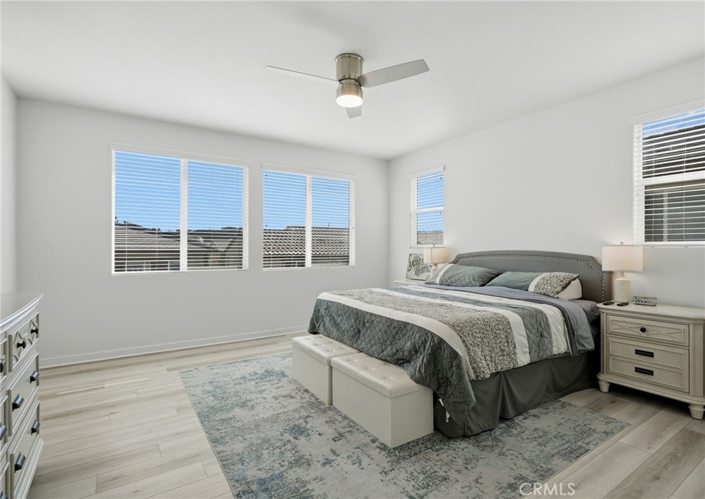 32243 Penstemon Way Temecula, CA 92591 - Photo 11 of 26 a spacious bedroom with a bed and a large window