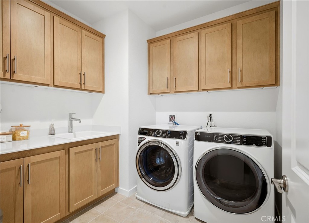 32243 Penstemon Way Temecula, CA 92591 - Photo 19 of 26 a utility room with sink dryer and washer