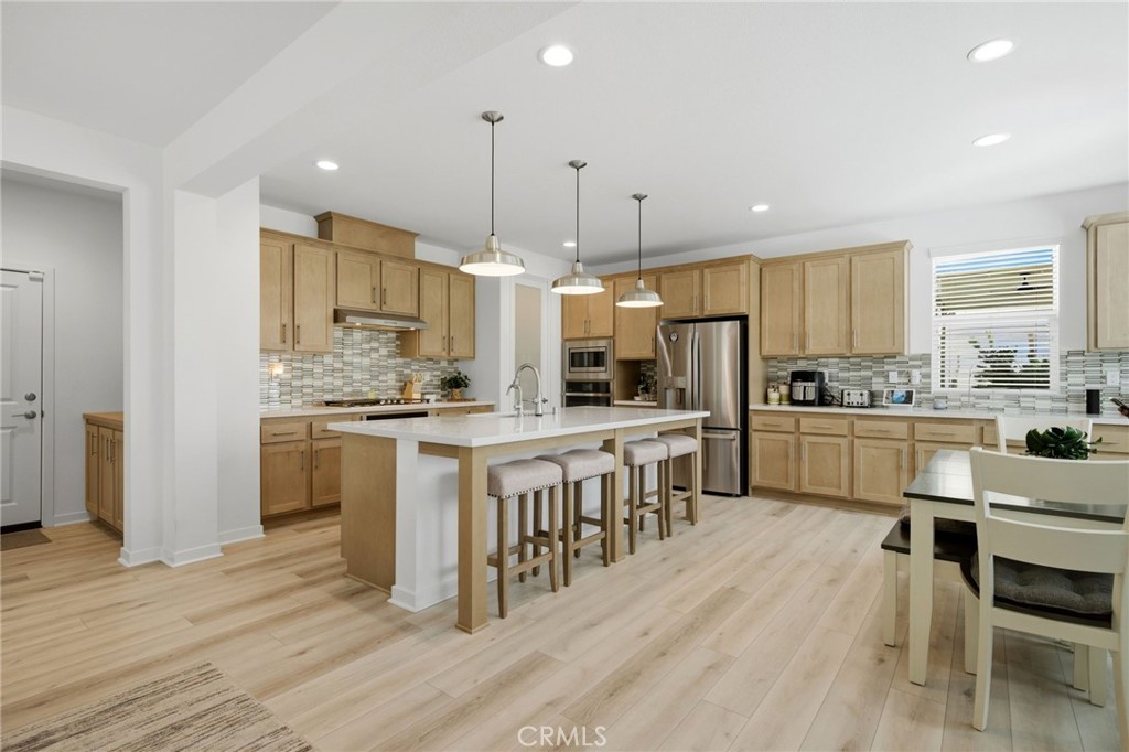 32243 Penstemon Way Temecula, CA 92591 - Photo 6 of 26 a kitchen with white cabinets and stainless steel appliances