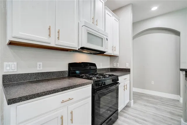 a kitchen with a refrigerator and a sink