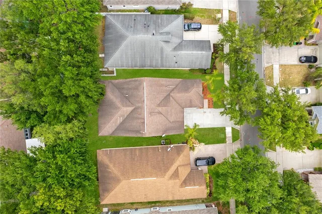 an aerial view of residential houses with outdoor space and street view