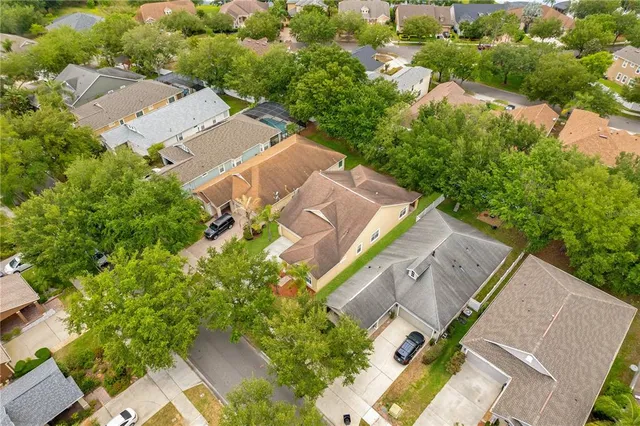 an aerial view of a house with a yard